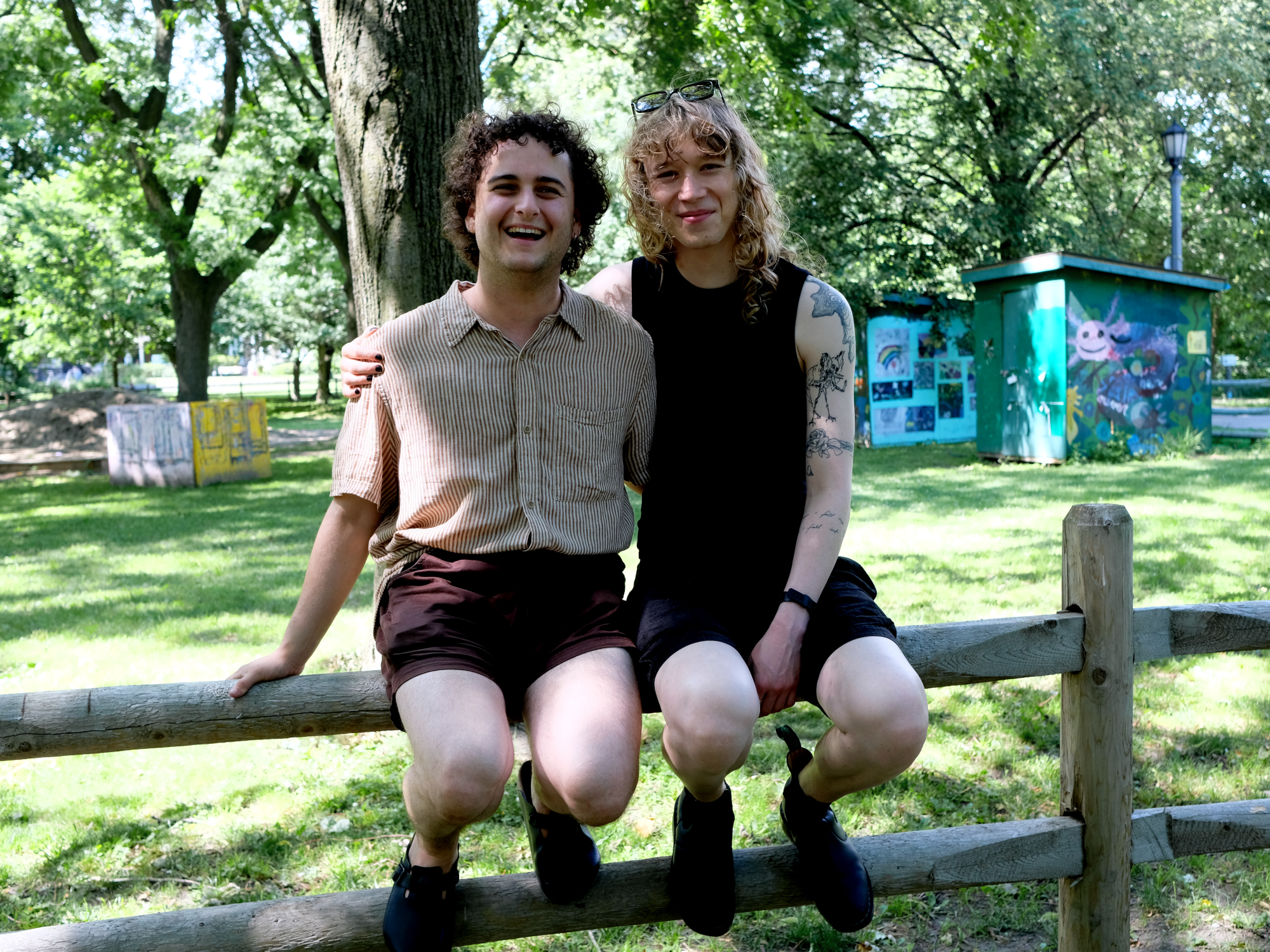 Wiley and Andi are crossing the street, with their arms around each other.